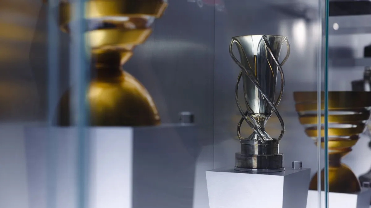 A trophy displayed in a lit glass case