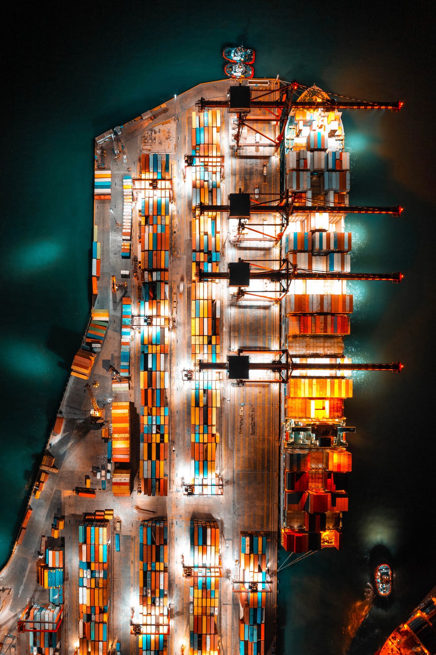 Shipping containers and cranes at a port, seen from above at night
