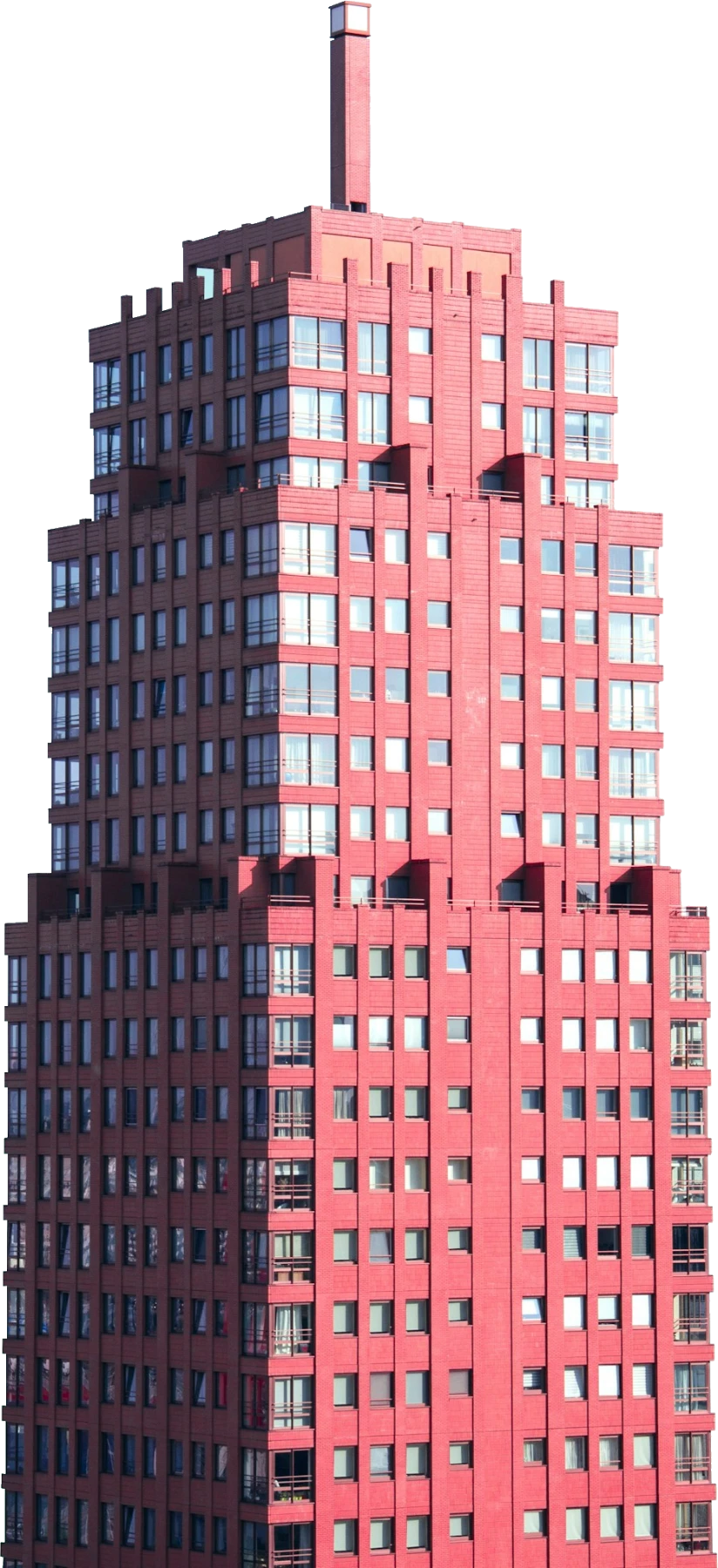 A red high-rise tower rising into a clear sky