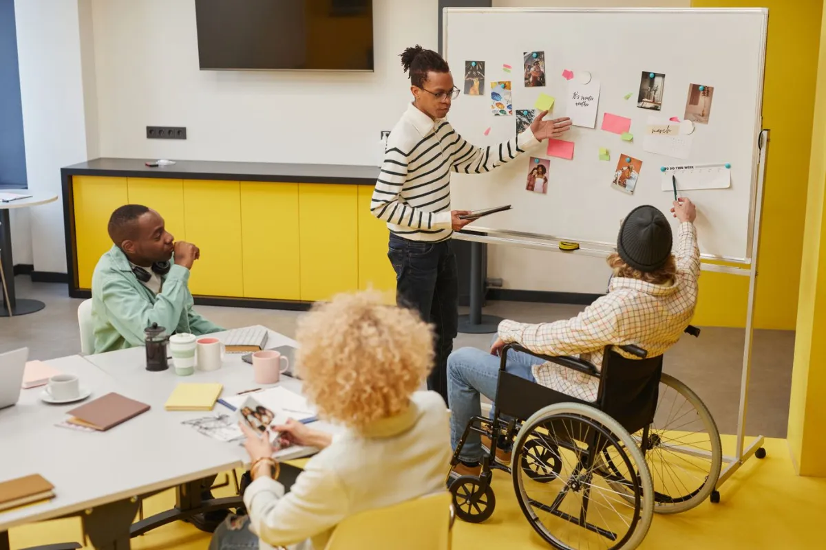 A trainer leading a workshop at a whiteboard