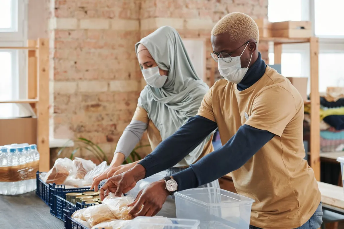 Volunteers packing food donations at a table